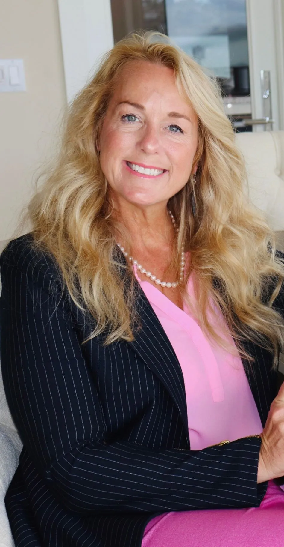 Kelly Willenborg smiling in a professional portrait with her hair and shoulders visible